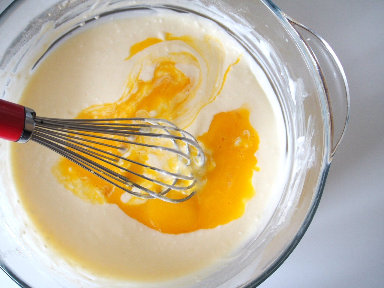 The cream cheese, butter are melted in the double boiler, together with the milk and oil. Egg yolks are added to the melted mixture.