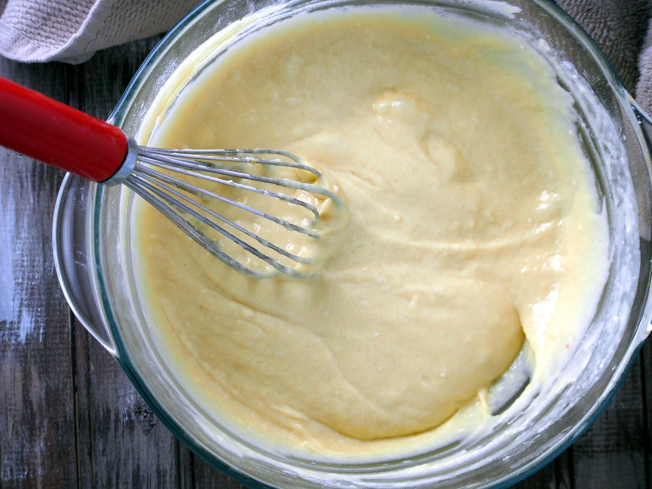 The flour mixture is added to the yolk batter to make a thick batter.