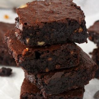 Four brownie squares stacked on top of one another.