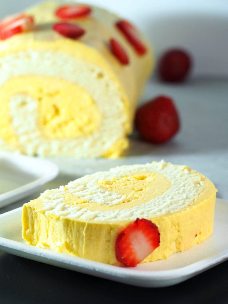 Mango cake roll that is soft and fluffy and iced with mango Swiss meringue buttercream.