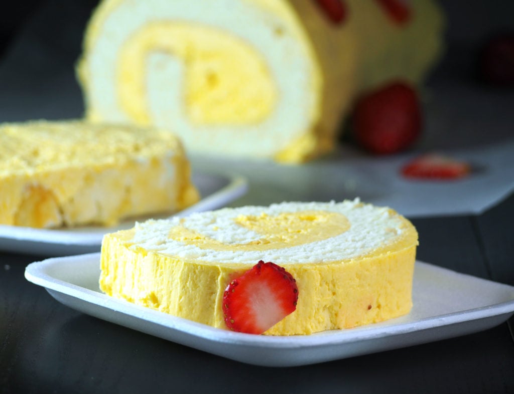 Mango cake roll that is soft and fluffy and iced with mango Swiss meringue buttercream.