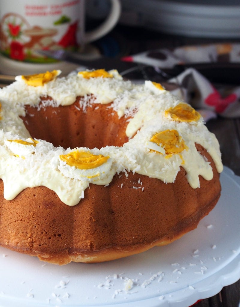 Bibingka style pound cake is a rich, dense cake filled with bits of salted eggs,  glazed with a creamy milk frosting, then topped with coconut flakes and more salted eggs. 