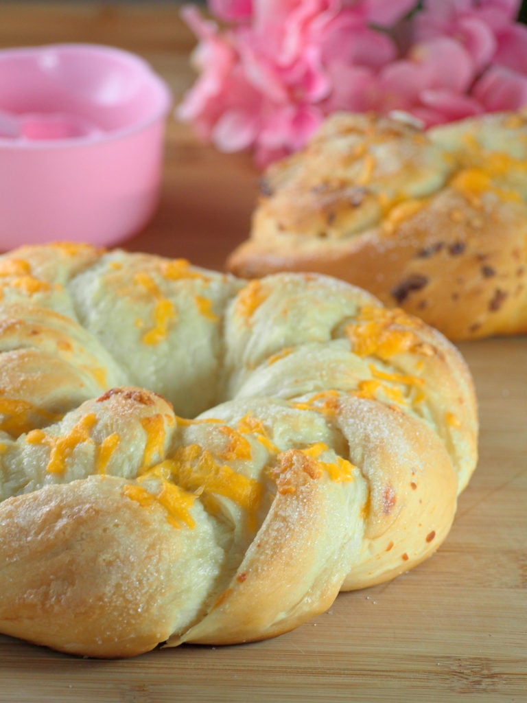 Soft cheddar cheese bread that is packed with cheddar cheese on top and sprinkled with sugar as a finishing touch.