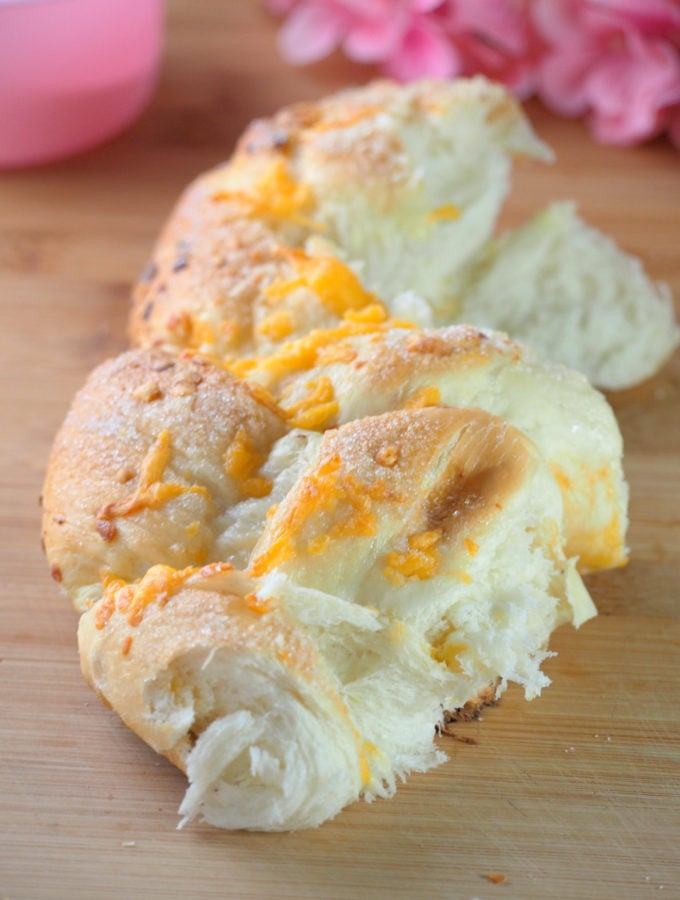 Soft cheddar cheese bread that is packed with cheddar cheese on top and sprinkled with sugar