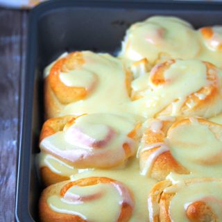 One pan of yema rolls with the yema glaze drizzled on top.