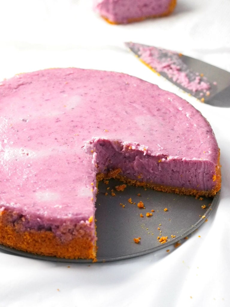 Ube cheesecake with one slice cut out.