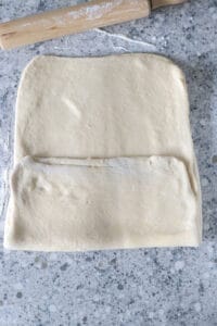 Folding the lower flap of the rectangle dough.