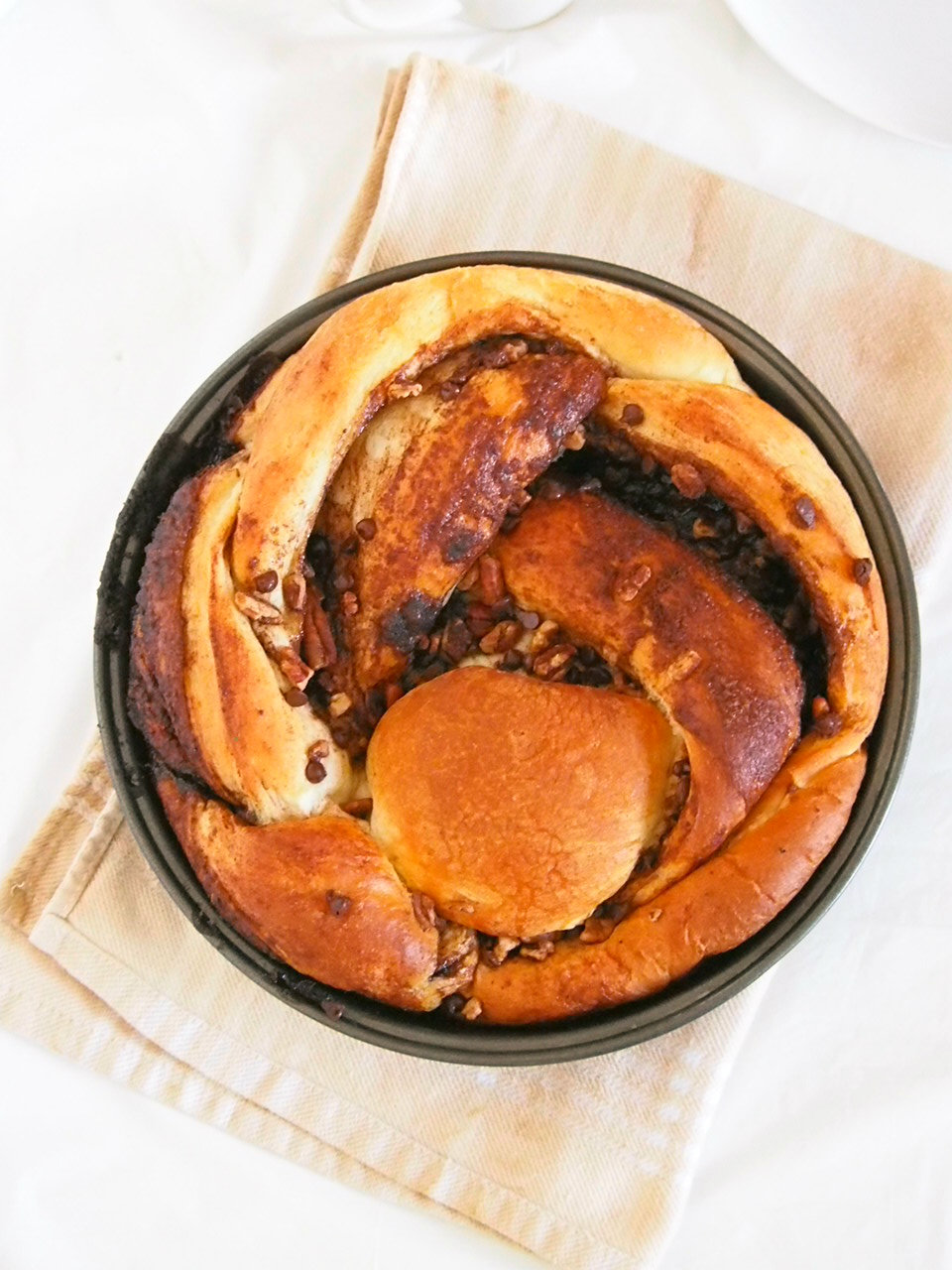 This Chocolate Pecan Cinnamon Bread is a soft, tasty bread braided with a delightful mixture of cinnamon sugar, cocoa, chocolate chips and pecan nuts. The addictive flavor and the soft texture of bread will have you pulling out a piece of this bread one after another.