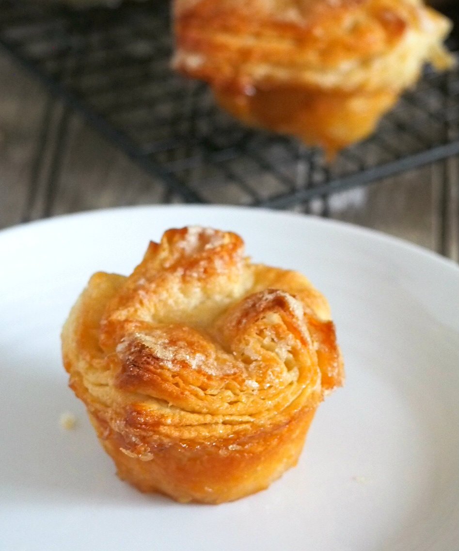 Kouign Amann are buttery layers of bread dough folded with a generous sprinkling of sugar in between the thin pastry layers.