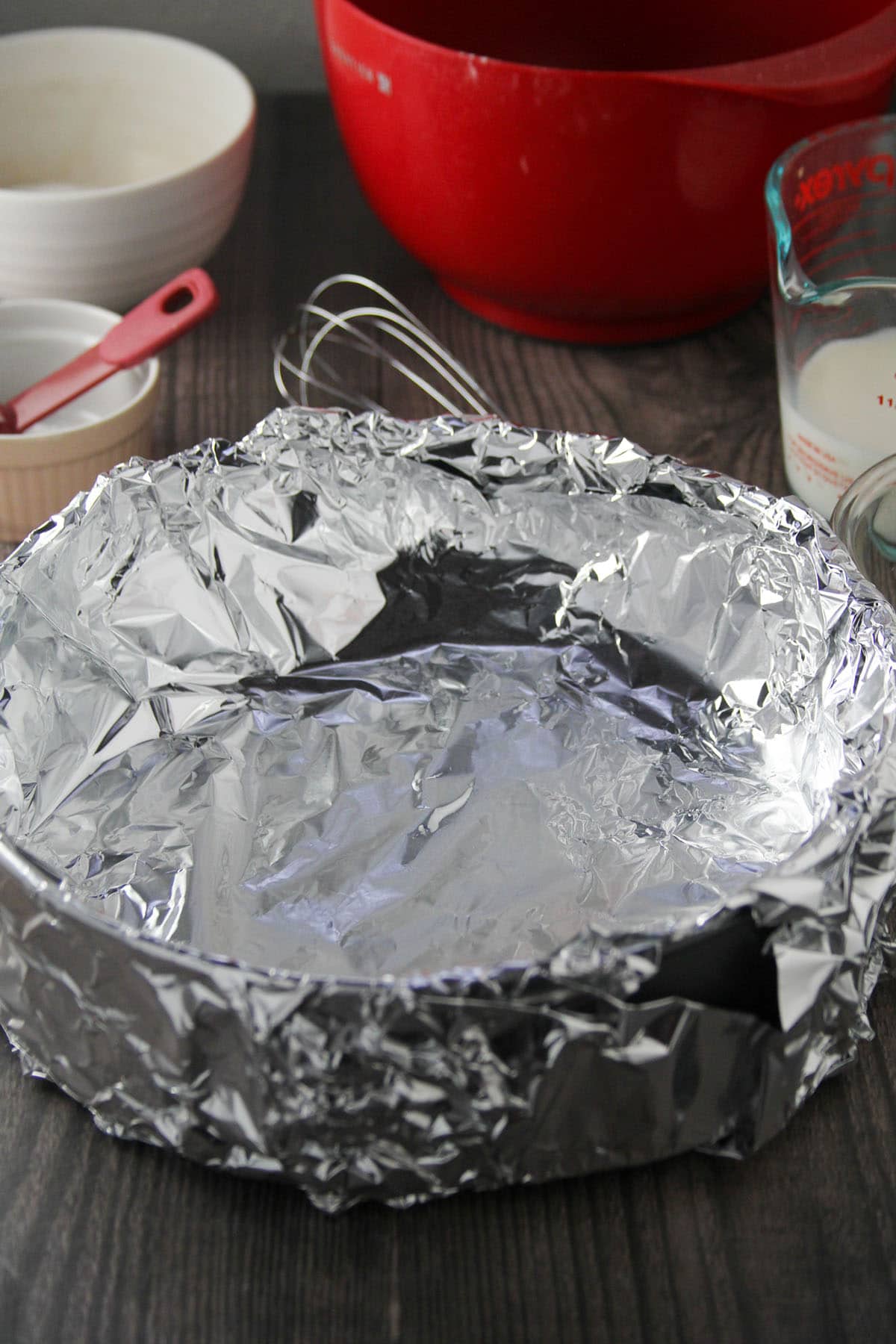 A ten inch spring-form pan lined with foil.