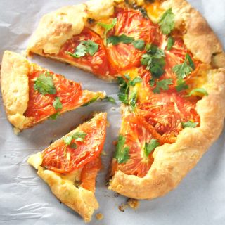 Serve this Cheese Tomato Galette as a snack or as a light meal and delight your guests with the appetizing combination of tomato and cheese enclosed in a crisp and flaky pastry.