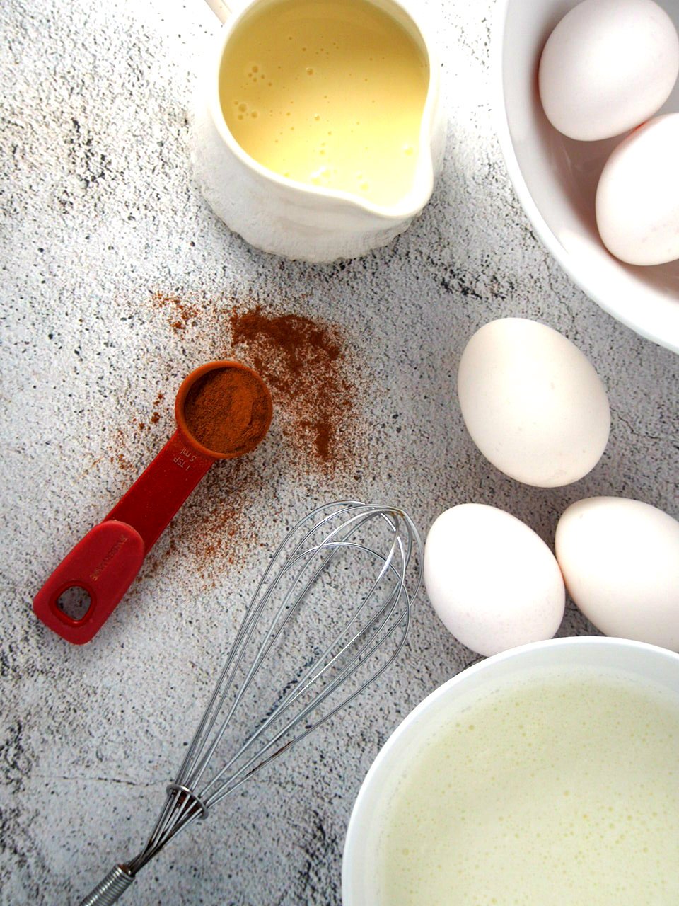 Some of the ingredients for making Cinnamon Flan: cinnamon, eggs, condensed milk and cream.