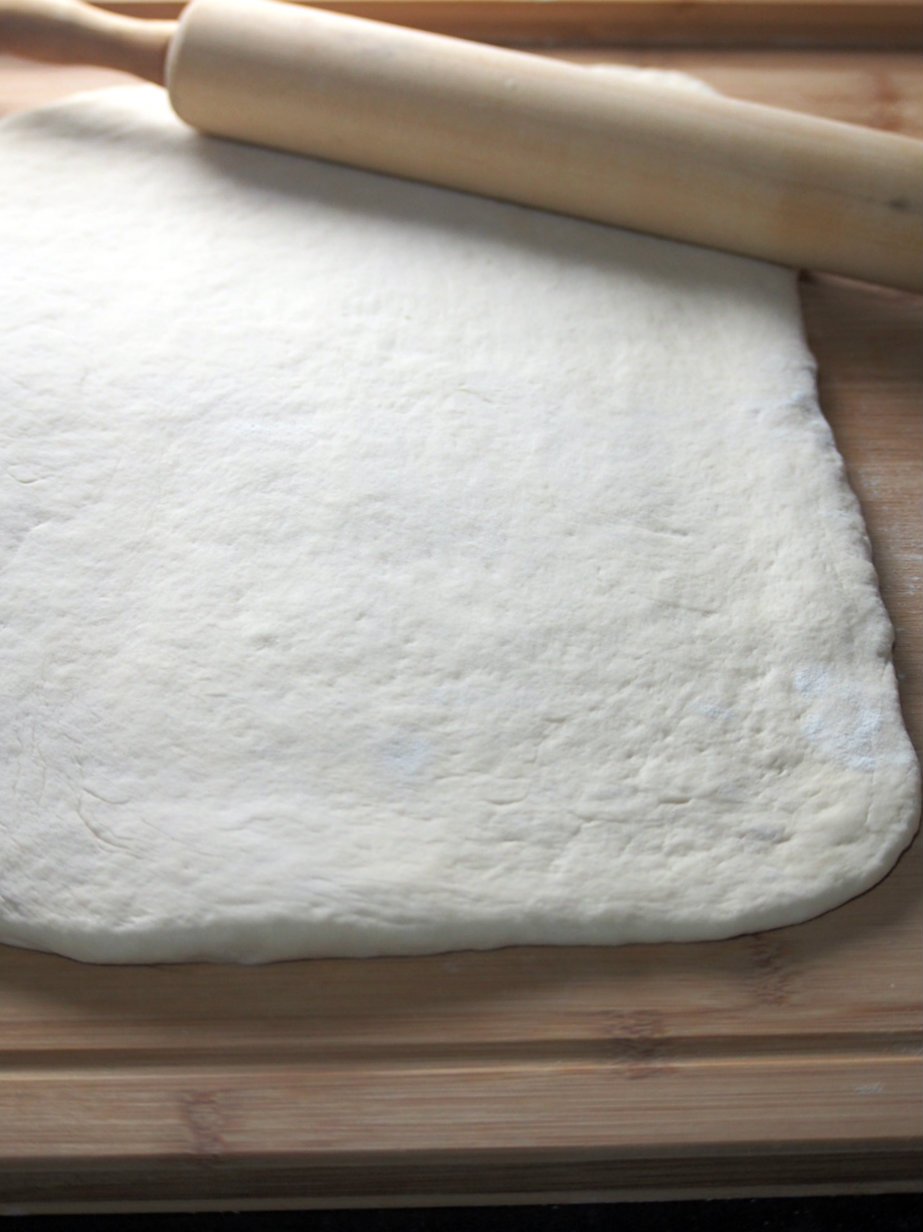 Rolling the dough into a 15x10 inch rectangle.