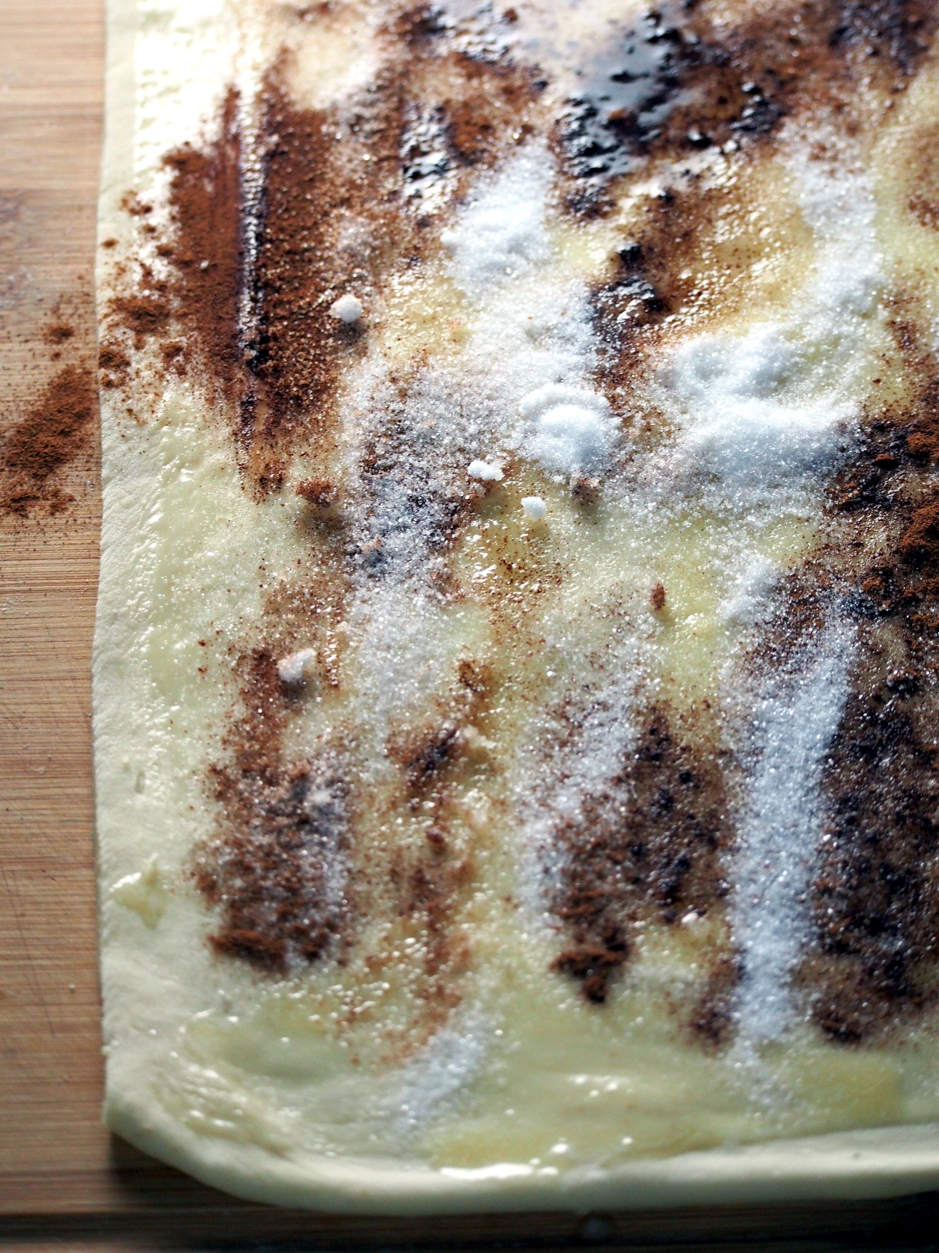 Cinnamon, butter and sugar spread on the dough.
