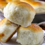 Close up shot of three pieces of Coconut bread (pani popo) on a small plate.