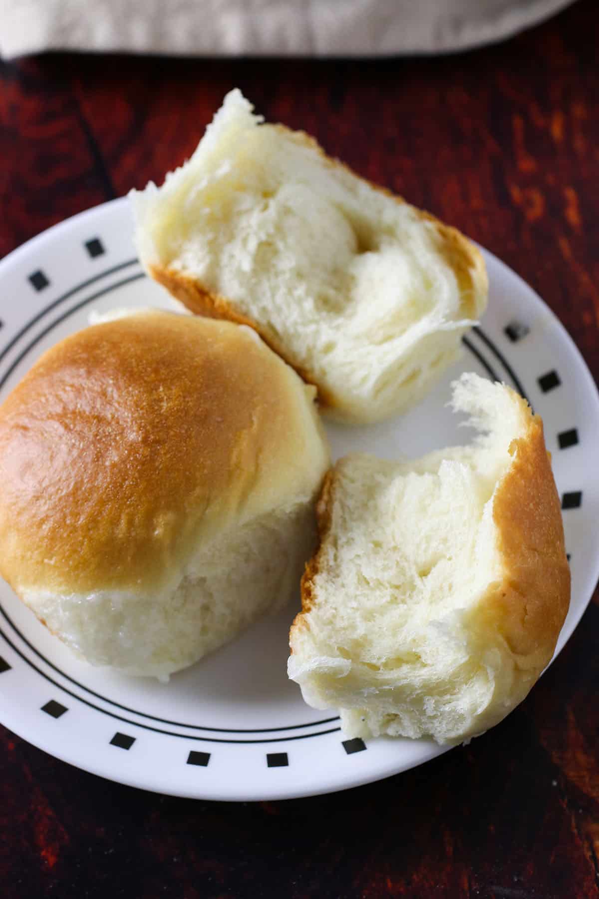 Coconut bread or pani popo on a small plate.