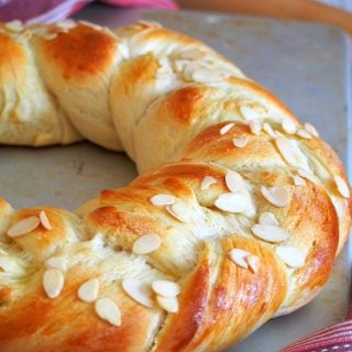 Finnish Pulla is a celebration bread braided beautifully like a wreath. It gets its nice flavor from the cardamom and it is adorned with crunchy almonds as finishing on top.