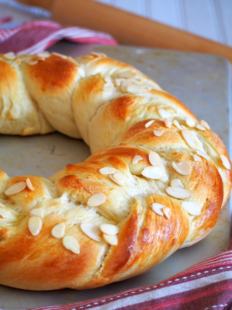 Finnish Pulla is a celebration bread braided beautifully like a wreath. It gets its nice flavor from the cardamom and it is adorned with crunchy almonds as finishing on top.