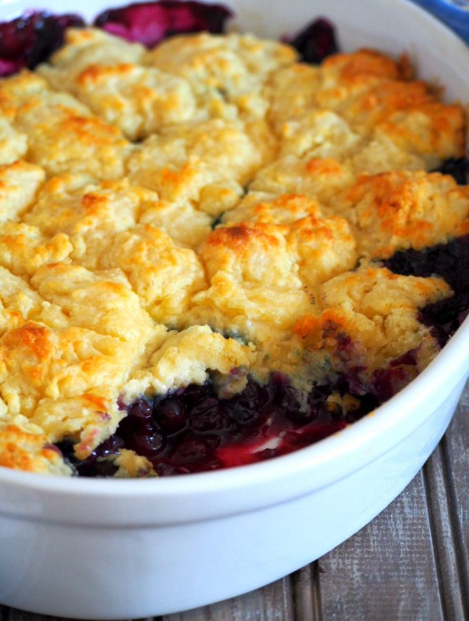 Blueberry cobbler with a scooped part on the front side.