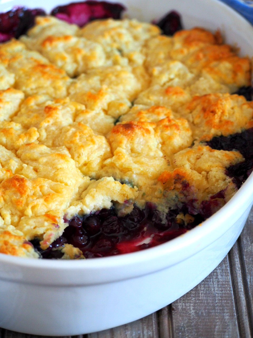 Blueberry cobbler with a scooped part on the front side.