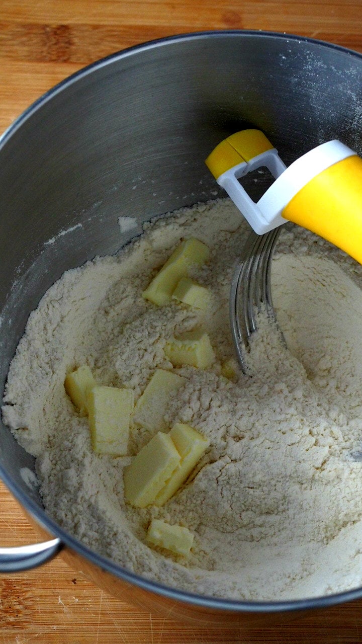 Cutting the butter into the flour using a pastry cutter. First step of making the cobbler pastry.