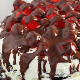 Close up view of Black Forest Icebox Cake. Cherries, chocolate syrup drippings and icebox cake layers.