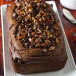 Chocolate chip loaf bread on a serving plate.
