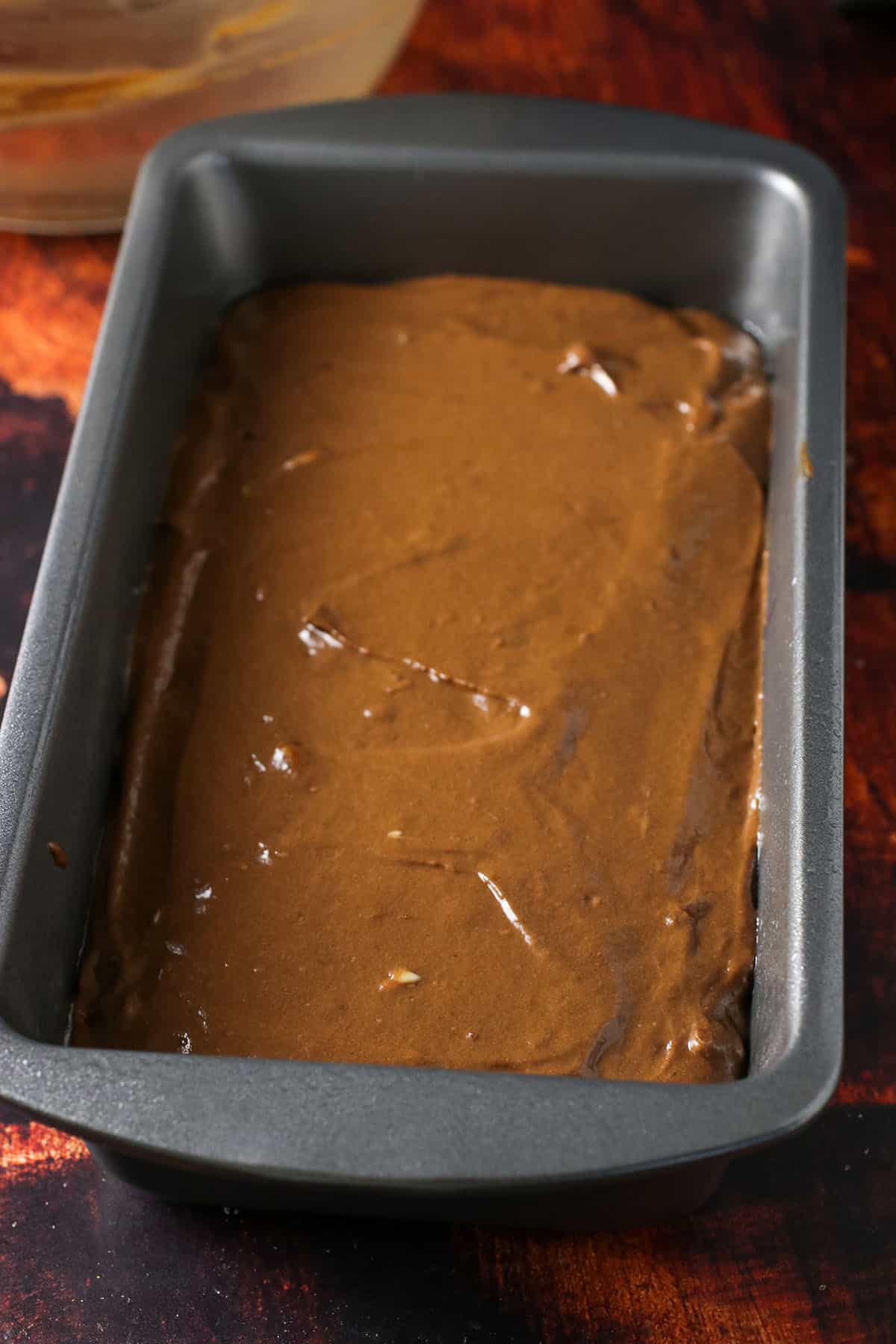 The chocolate chip loaf bread batter in a loaf pan, ready for baking.