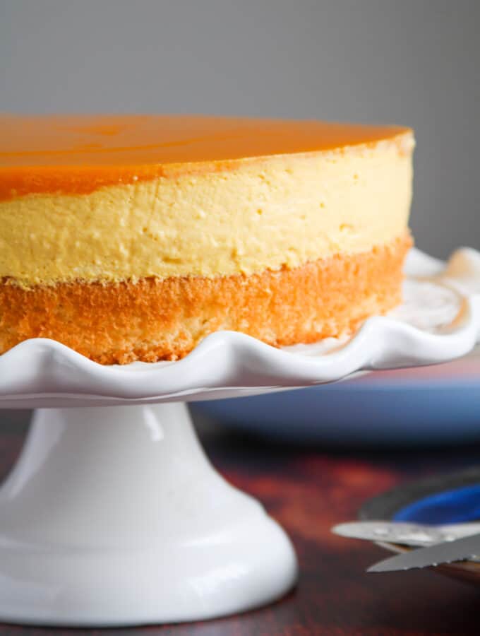 Mango Mousse Cake on a cake stand.