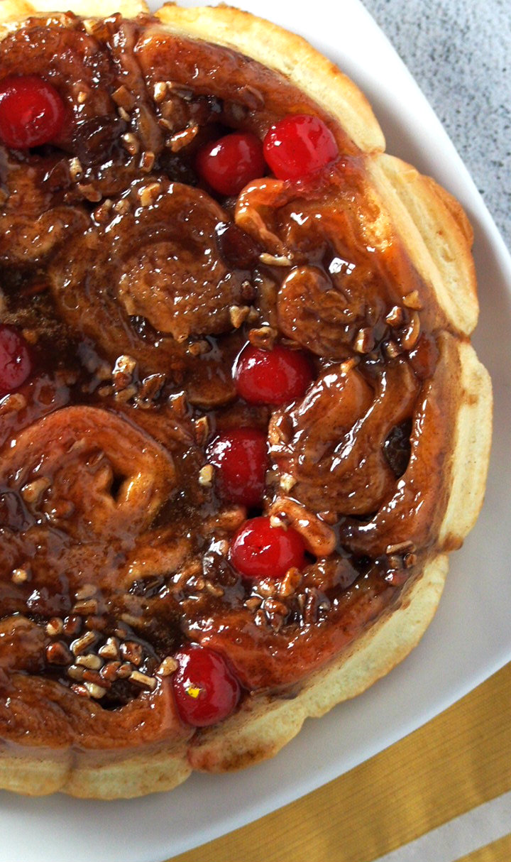 Top angle of chelsea buns showing the cherries, pecans and raisins toppings.