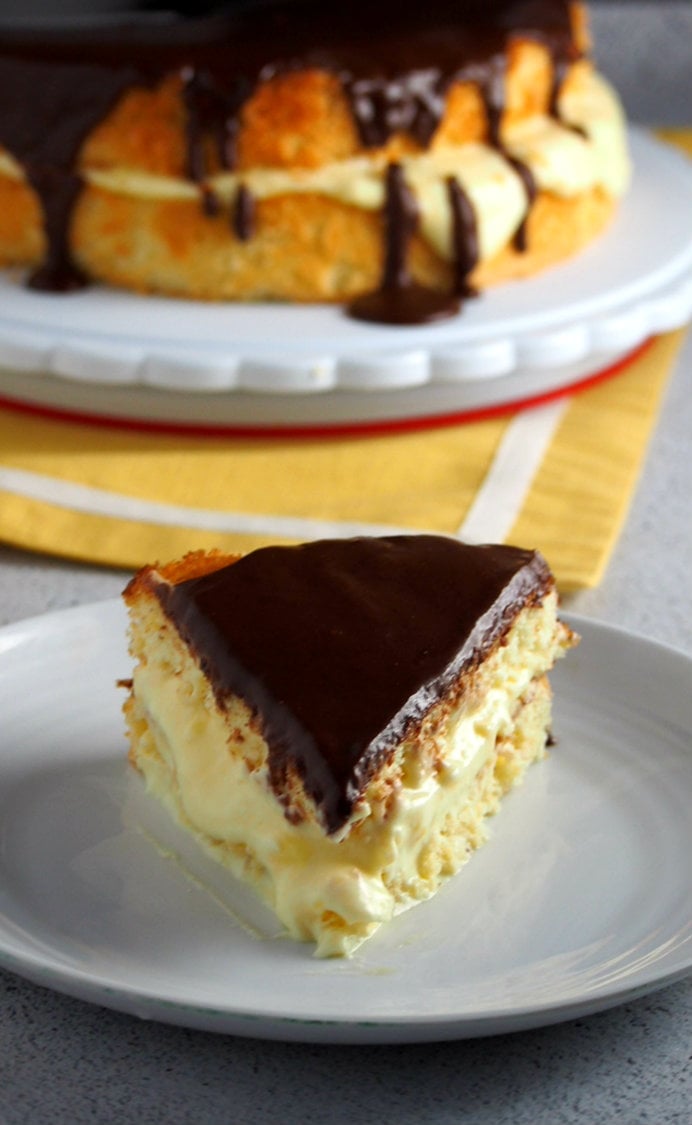 A slice of Boston Cream Pie on a saucer plate.