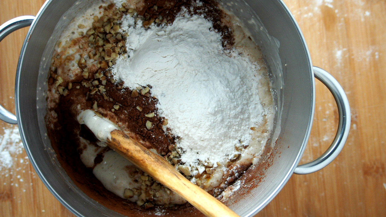 Stirring in some dry ingredients to the proofed yeast for Chocolate Bread Dough.