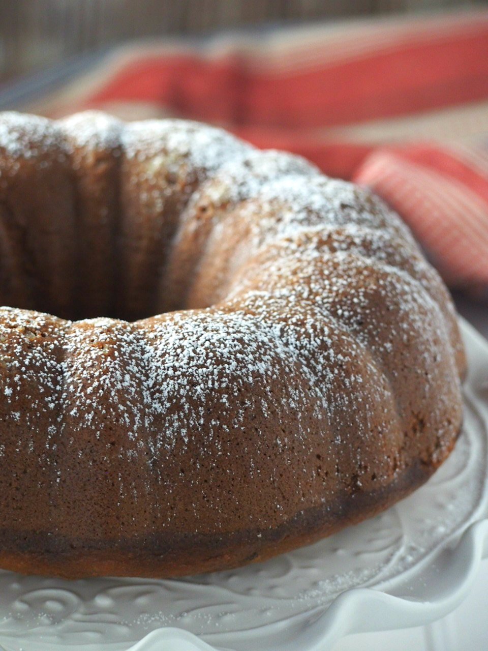 Closer view of the whole banana bundt cake on a serving plate.