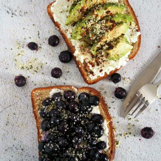 Top view of avocado and blueberry toasts.