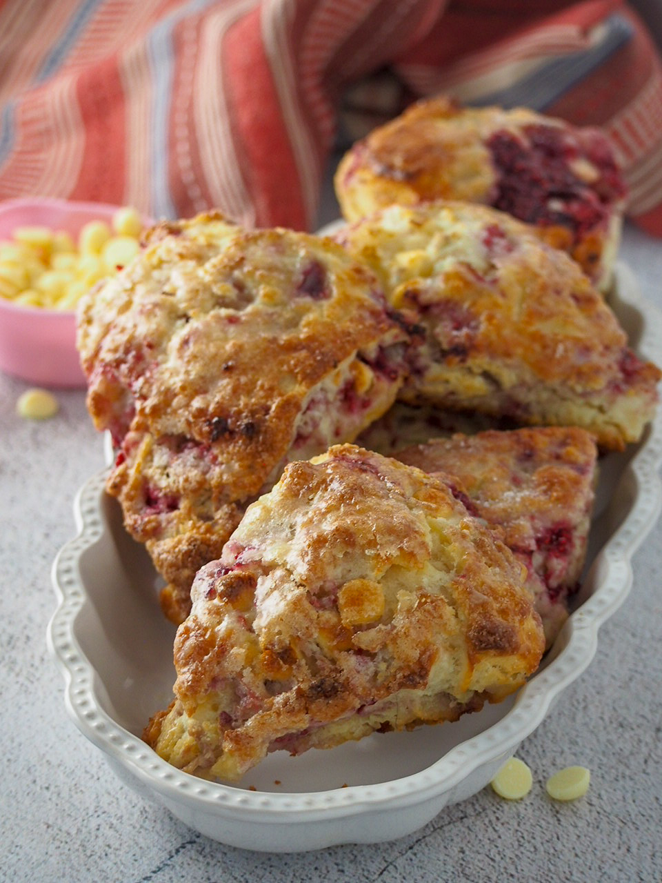 Raspberry scones on a serving plate.