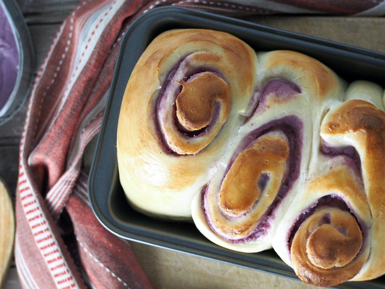 Closer shot of the ube loaf bread, showing the swirls that are filled with the ube filling.