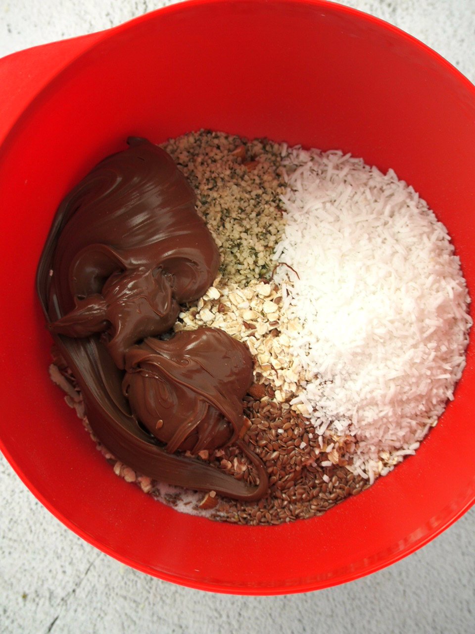 The ingredients for Nutella Energy balls combined in a mixing bowl.