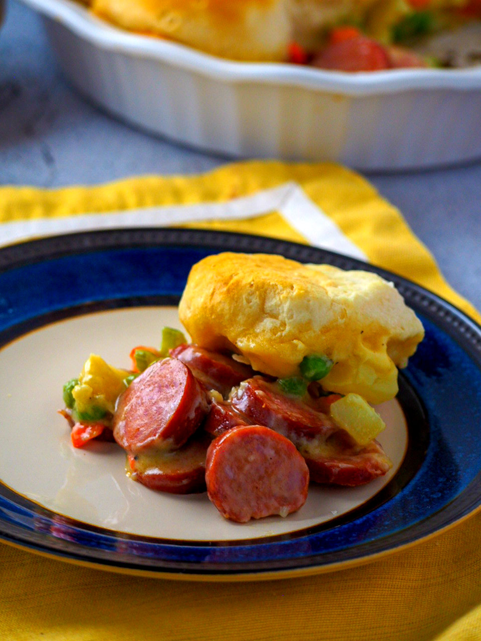 A serving of smokies and veggies pot pie in a plate.