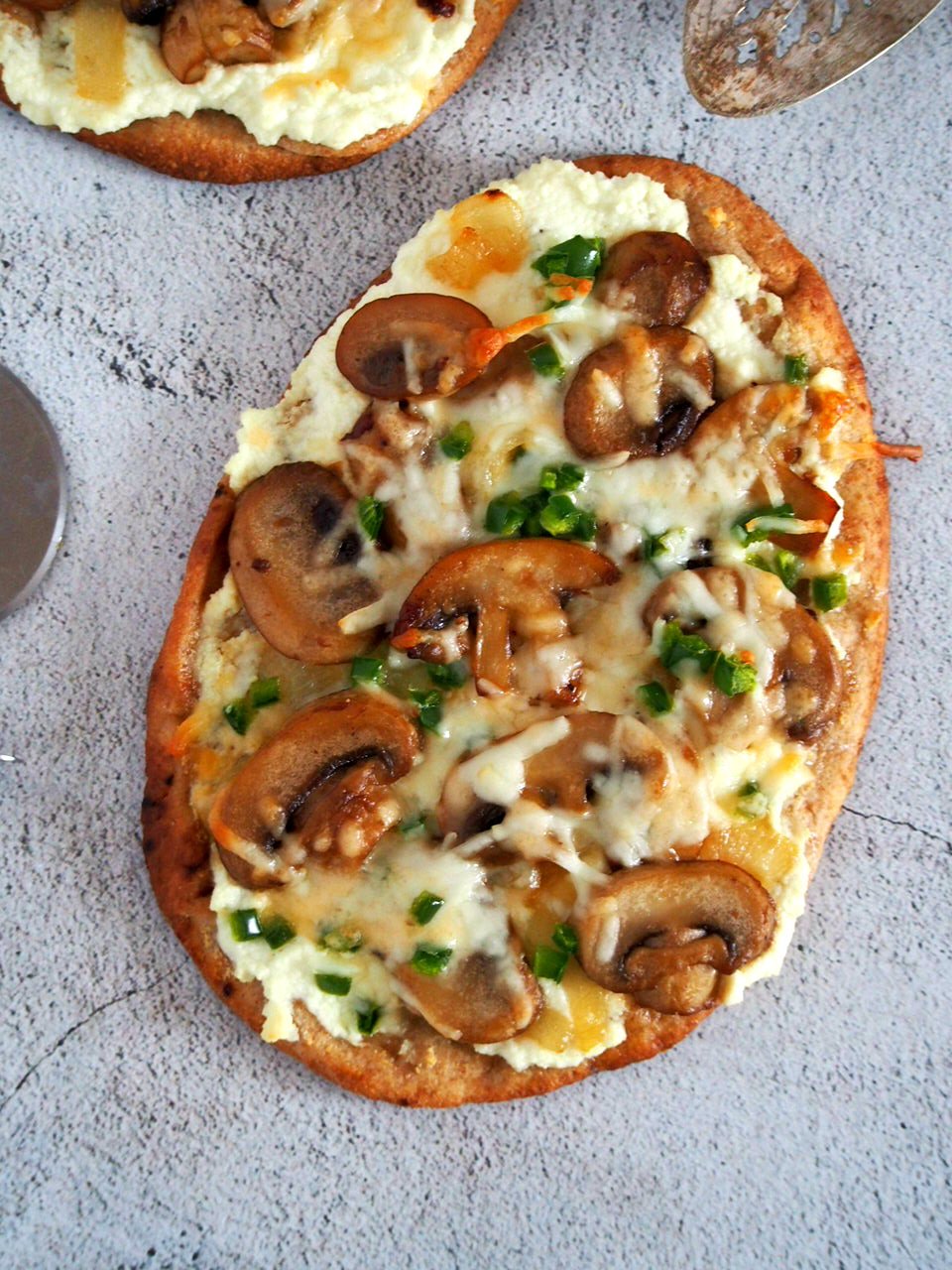 Top angle shot of Mushroom Jalapeno Naan Pizza.