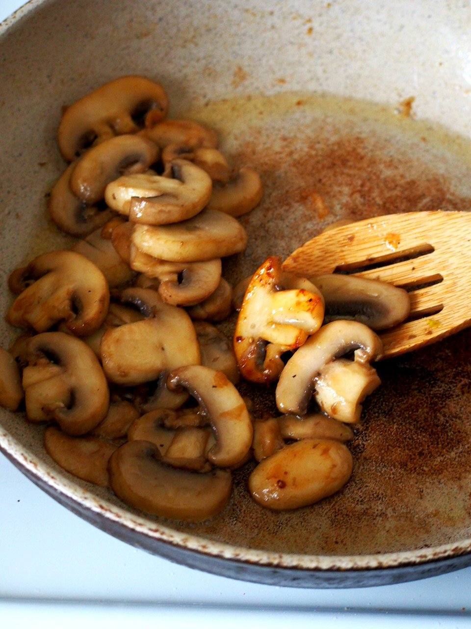 Browning the mushrooms in a pan.