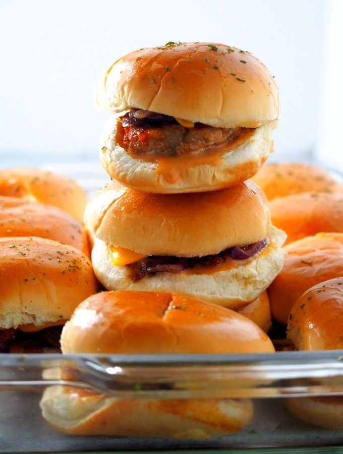 Chicken Burger Sliders stacked and lined up in a baking dish.