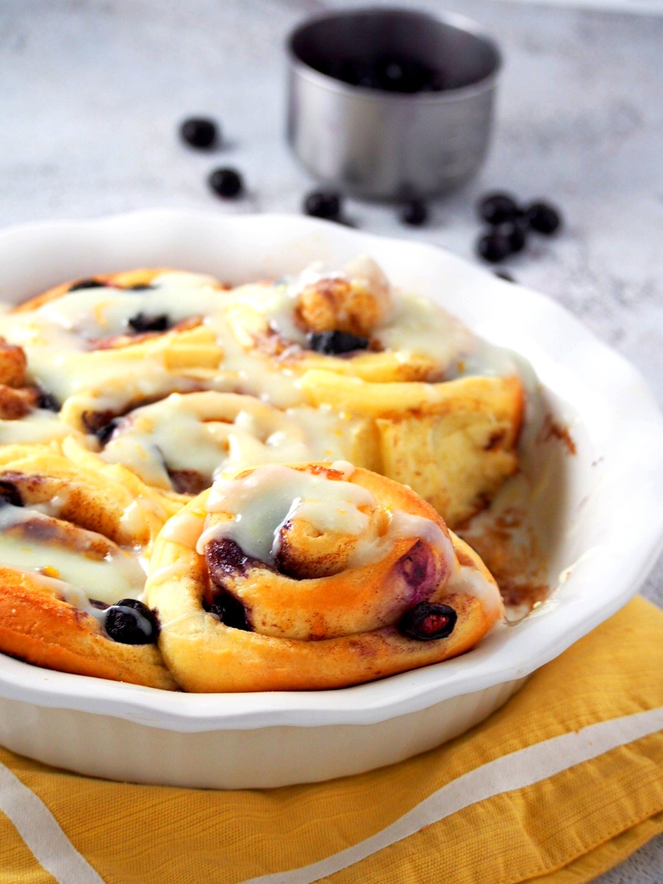 Close shot of Blueberry Cinnamon Rolls in a pan.