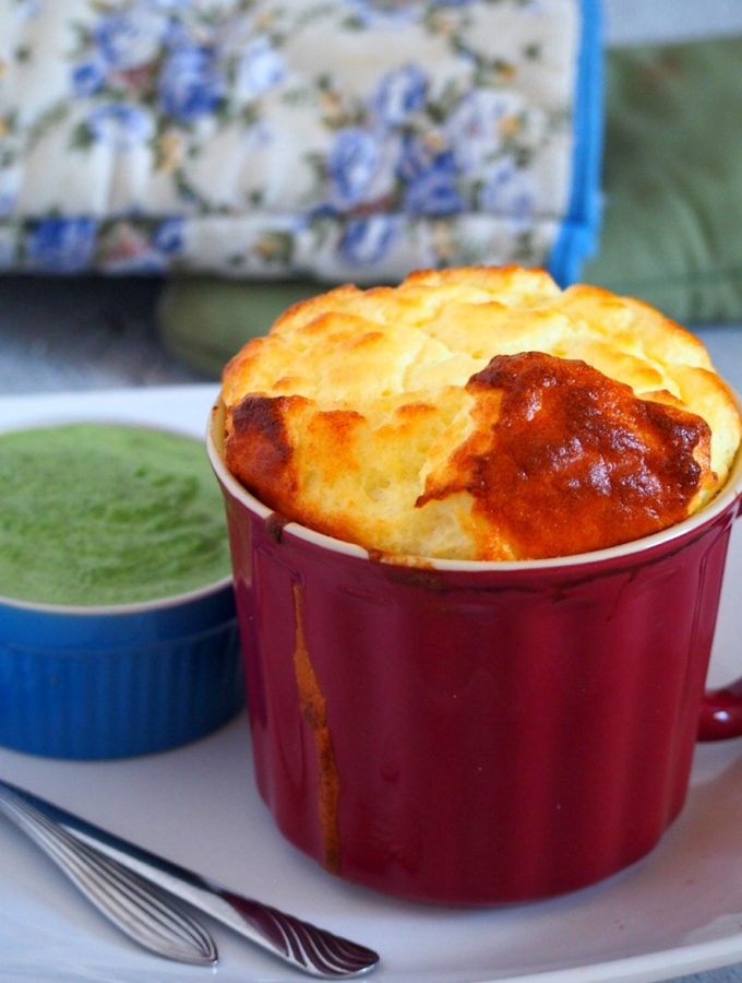 One mug of goat cheese souffle and a creamed spinach sauce on the side.