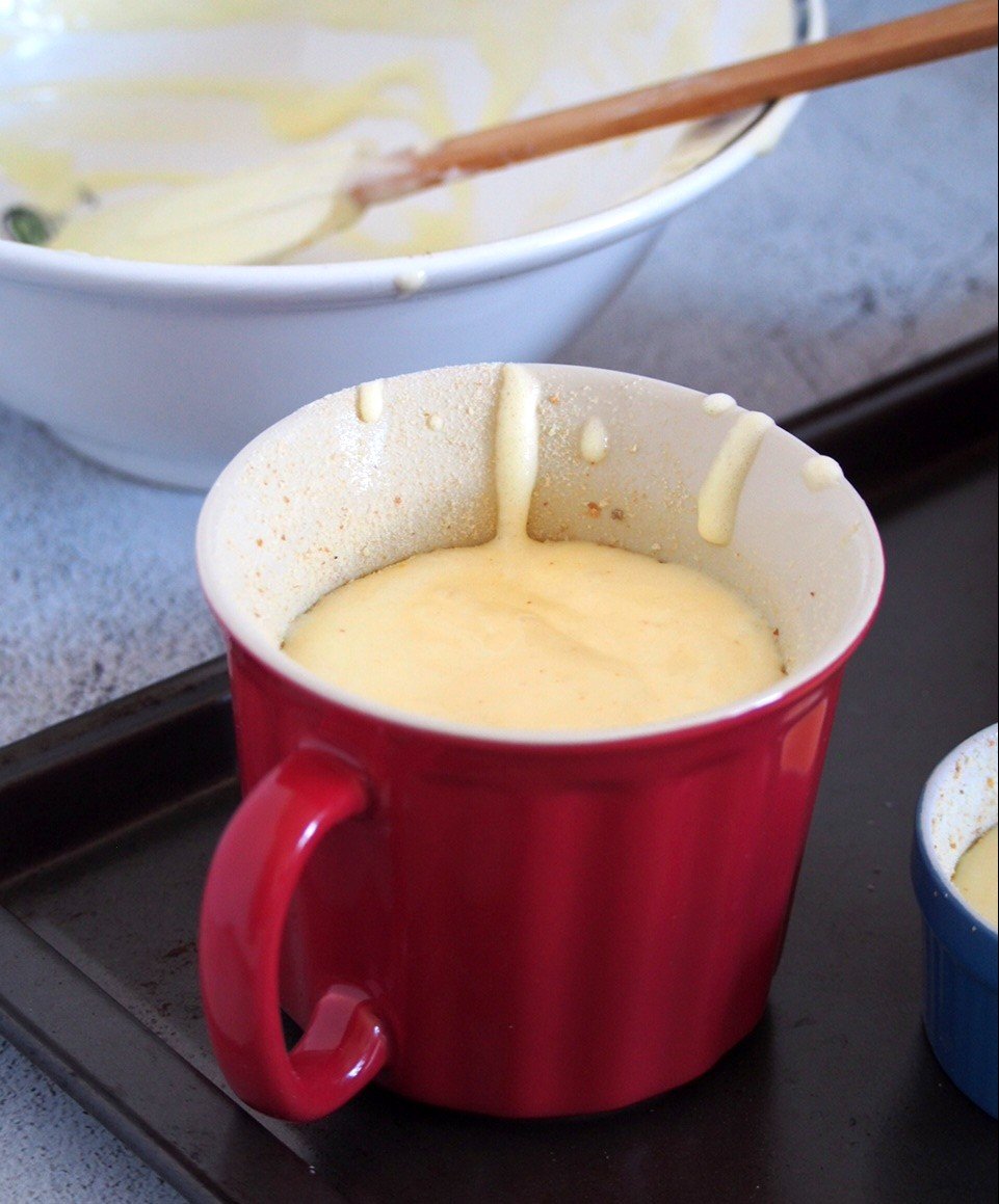 Goat cheese souffle batter in a mug, ready for baking.