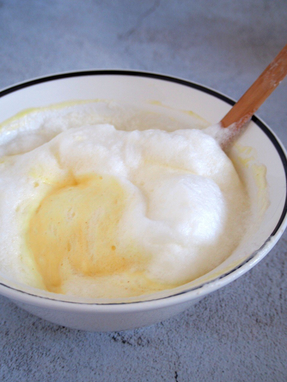 The egg whites and yolk batter being mixed to make the souffle.