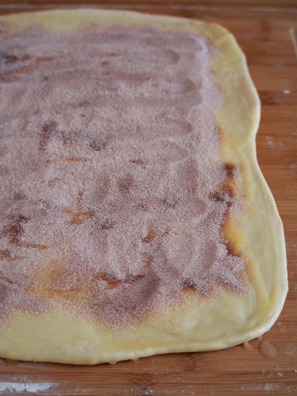 The rectangular dough with filling spread all over.