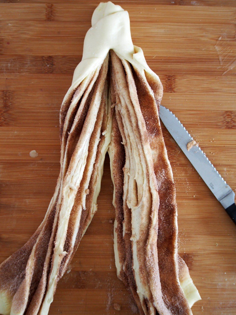 The cinnamon bread log split into half vertically.
