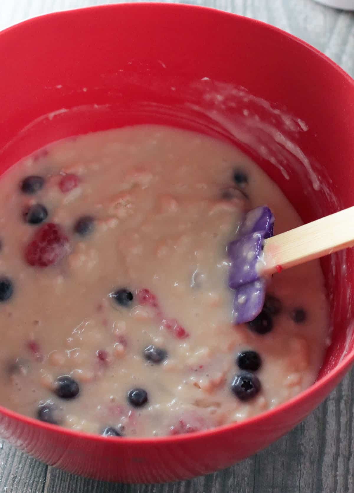 Mixing the easy berry cake batter in a bowl.