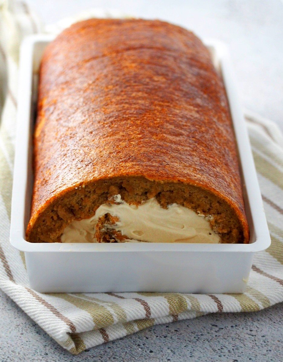 Coffee Swiss Roll cake in a cake container.