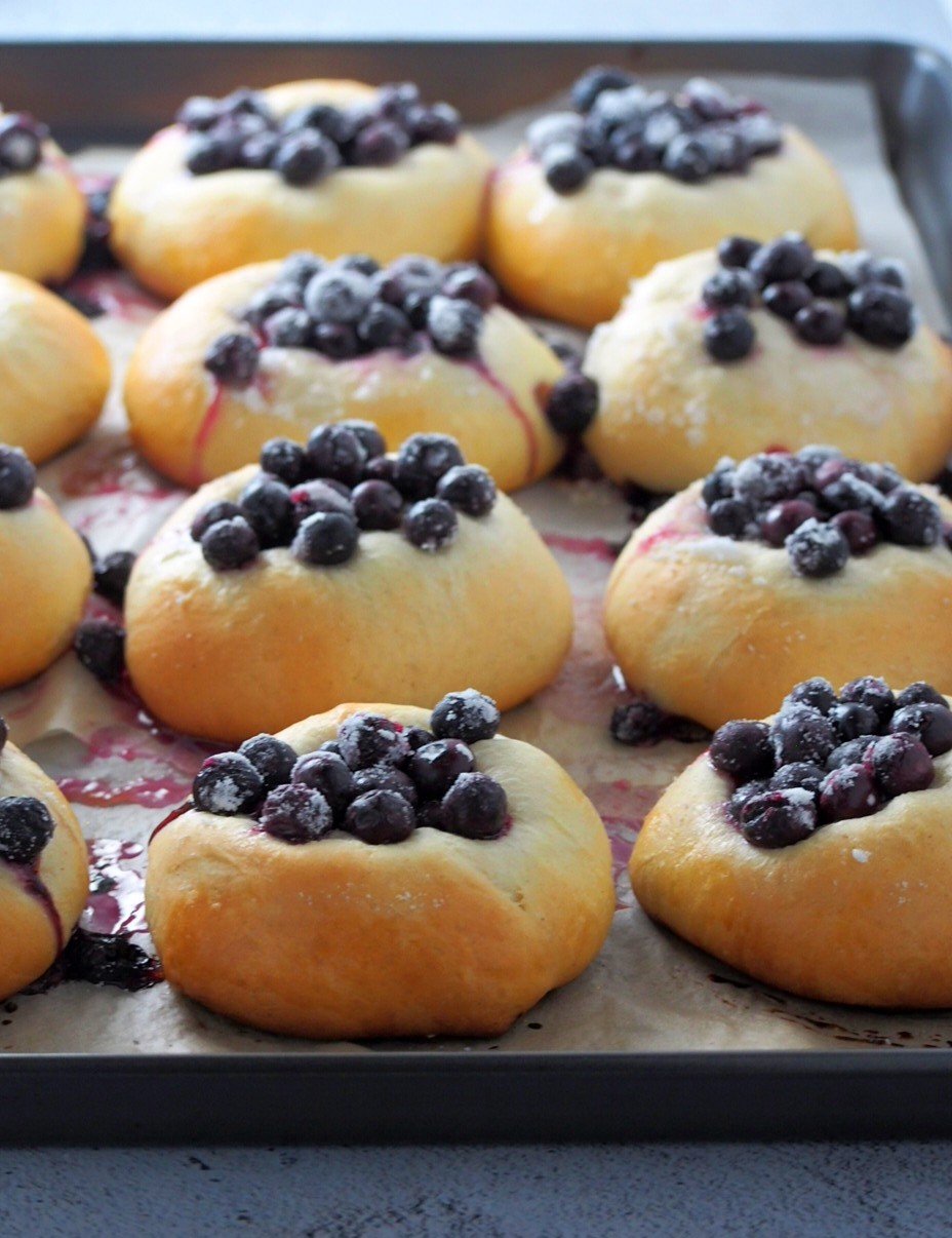 Finnish blueberry buns in the baking pan, freshly baked.
